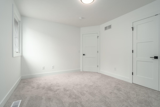 empty room with light colored carpet