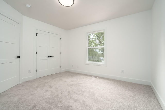 unfurnished bedroom featuring light colored carpet