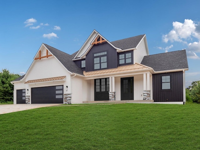 view of front of home featuring a front yard, a porch, and a garage