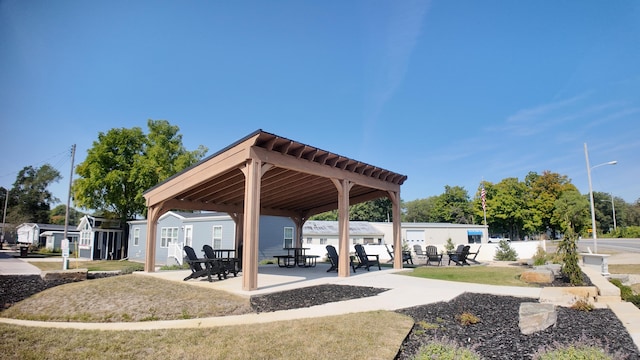 view of property's community featuring a yard and a patio area