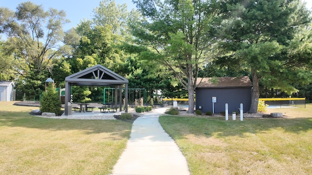 view of property's community with a lawn, a patio, and a gazebo