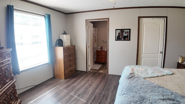 bedroom with ornamental molding, dark hardwood / wood-style floors, and ensuite bathroom