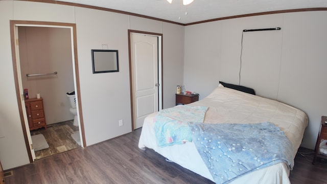 bedroom featuring connected bathroom, hardwood / wood-style flooring, and crown molding