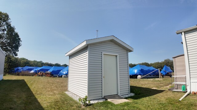 view of outbuilding with a lawn