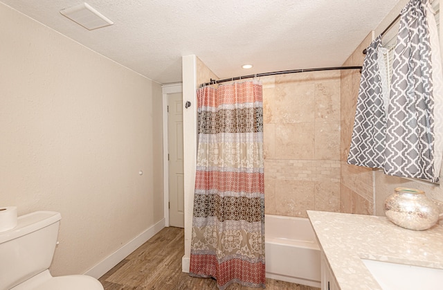 full bathroom featuring a textured ceiling, shower / tub combo with curtain, toilet, and hardwood / wood-style flooring