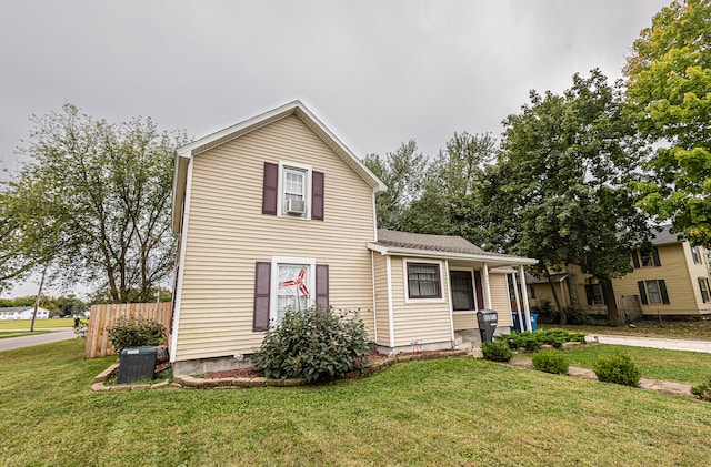 view of front of home featuring a front yard and cooling unit