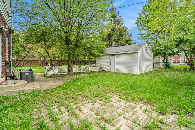 view of yard with a storage unit and central air condition unit