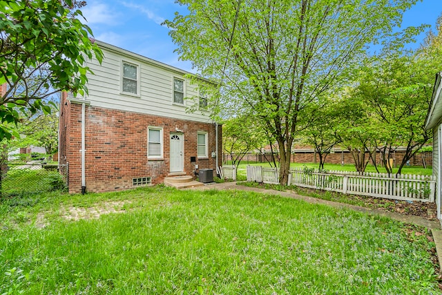 exterior space featuring central AC and a front yard