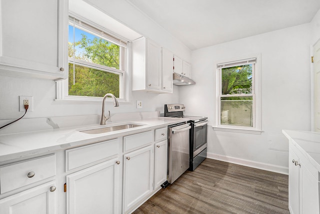 kitchen featuring white cabinets, appliances with stainless steel finishes, plenty of natural light, and sink