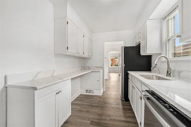 kitchen with dark hardwood / wood-style flooring, white cabinets, and stainless steel dishwasher