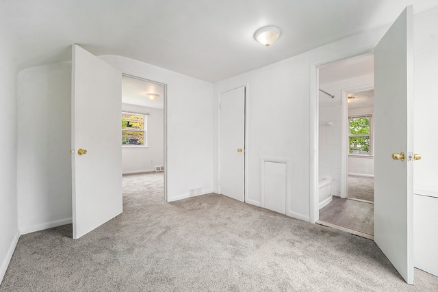 unfurnished bedroom with light carpet