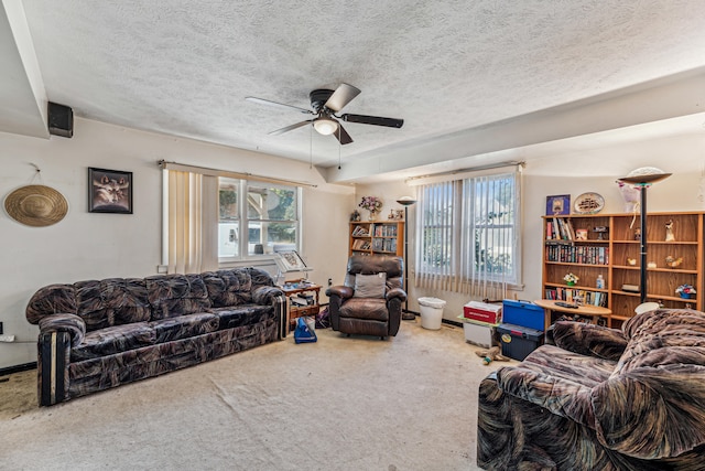 carpeted living room with ceiling fan and a textured ceiling