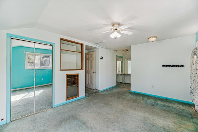 unfurnished bedroom with carpet, vaulted ceiling, ceiling fan, and a closet