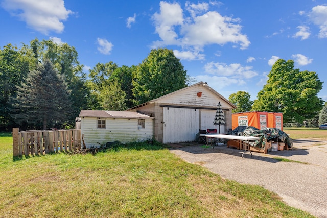 view of property exterior featuring a yard and a storage unit