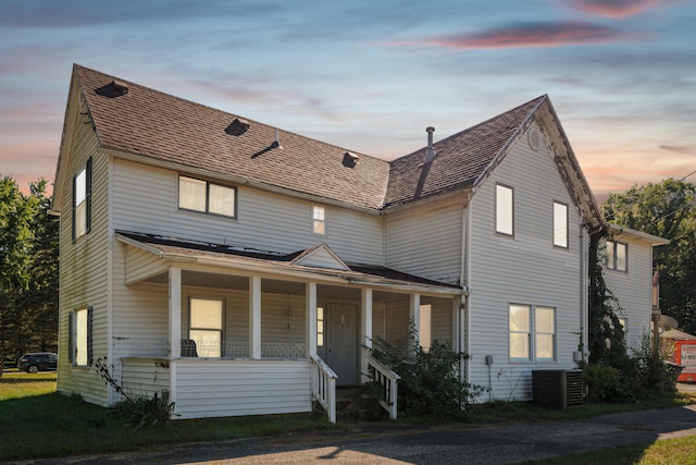 view of front of property with a porch and central AC