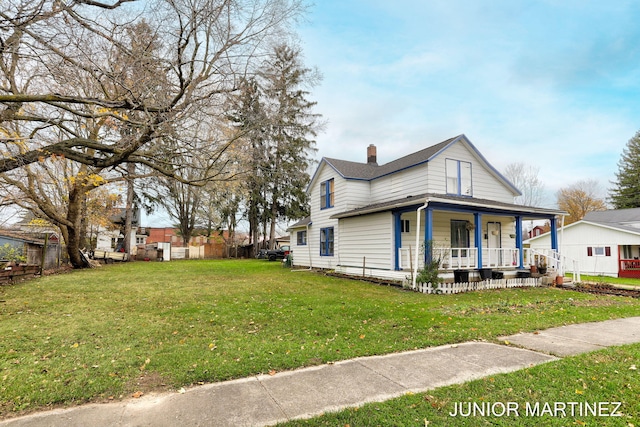 view of front of home featuring a front yard and covered porch