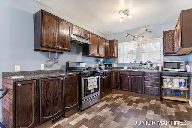 kitchen with appliances with stainless steel finishes, dark brown cabinetry, and sink