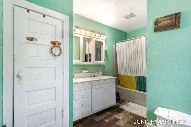 bathroom featuring shower / tub combo, wood-type flooring, a textured ceiling, and vanity