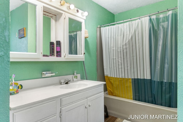 bathroom featuring vanity, shower / tub combo, and a textured ceiling