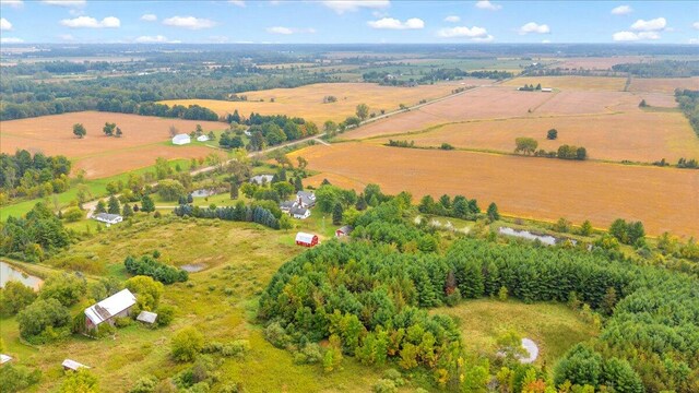 birds eye view of property featuring a rural view