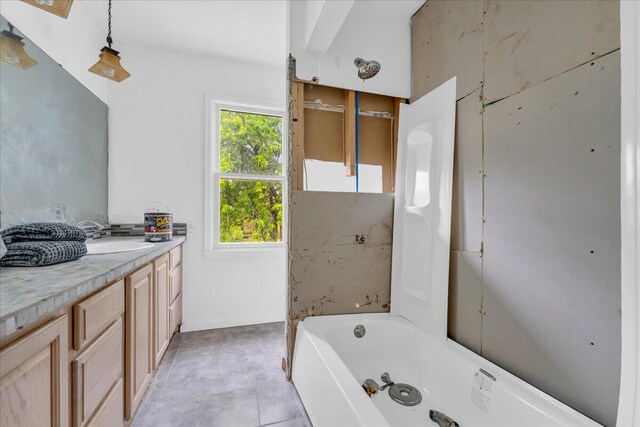 bathroom featuring a bath and vanity