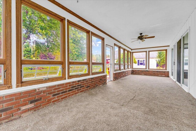 unfurnished sunroom with a wealth of natural light and ceiling fan