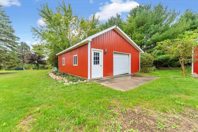 view of outbuilding featuring a lawn and a garage