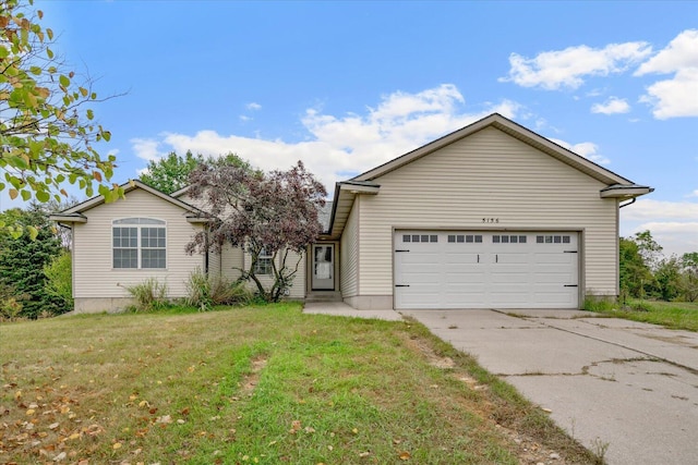 view of front of house with a front yard and a garage