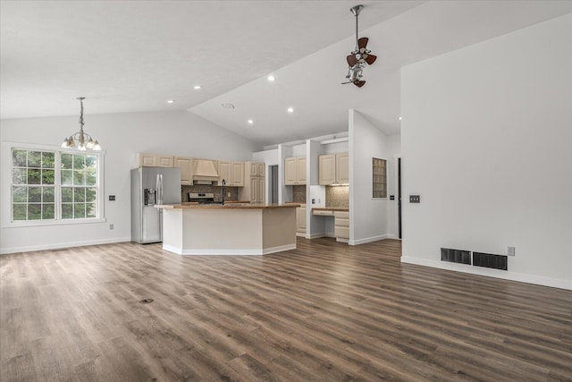 kitchen with appliances with stainless steel finishes, hanging light fixtures, decorative backsplash, dark hardwood / wood-style flooring, and a notable chandelier