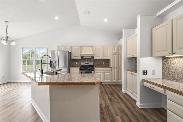 kitchen with tasteful backsplash, decorative light fixtures, a center island with sink, appliances with stainless steel finishes, and dark hardwood / wood-style flooring