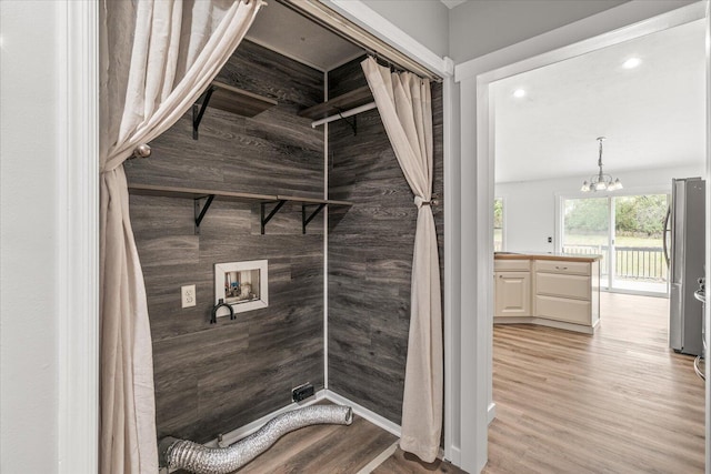 bathroom with vanity, an inviting chandelier, and hardwood / wood-style floors