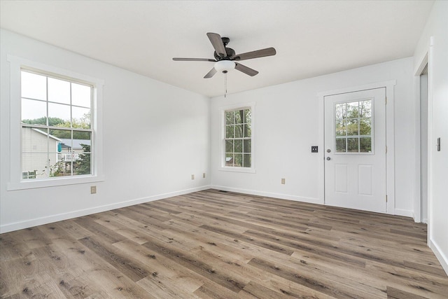 entryway with hardwood / wood-style floors, ceiling fan, and a wealth of natural light