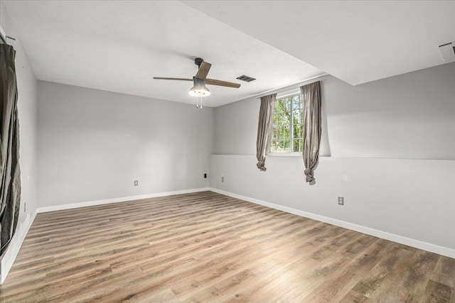 spare room featuring ceiling fan and hardwood / wood-style flooring