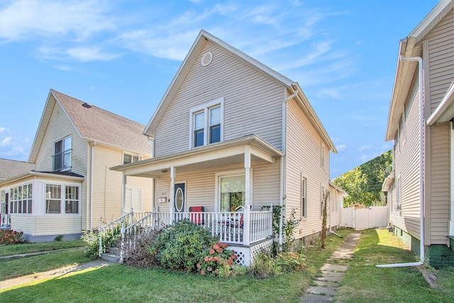 front of property featuring covered porch and a front yard