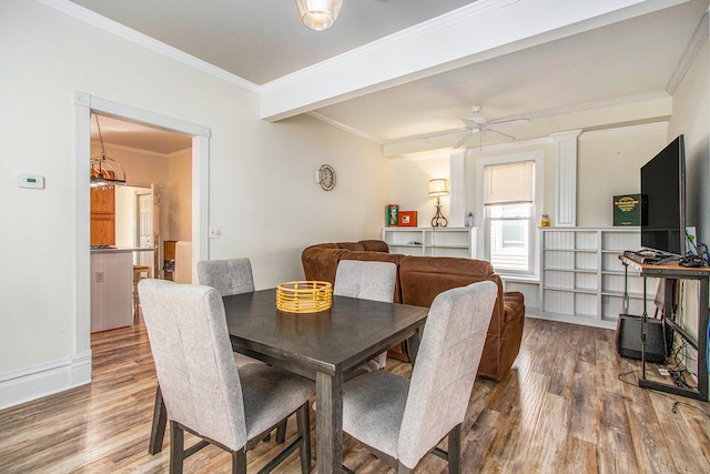 dining area with ceiling fan, hardwood / wood-style flooring, crown molding, and ornate columns