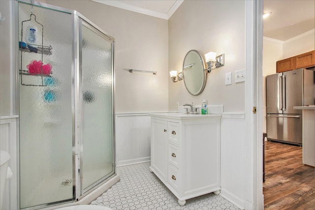 bathroom with crown molding, a shower with door, hardwood / wood-style floors, and vanity