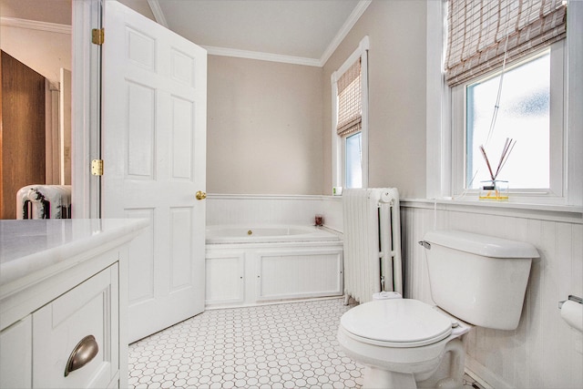 bathroom with a tub to relax in, ornamental molding, and toilet