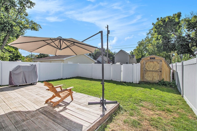 view of yard featuring a storage shed and a wooden deck