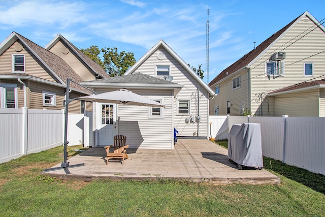 rear view of house featuring a patio and a yard