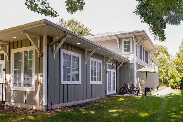 view of side of home featuring a patio area and a yard