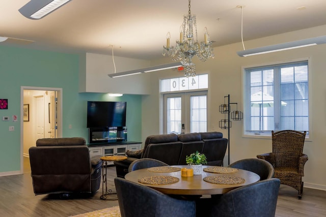 dining space featuring an inviting chandelier and hardwood / wood-style flooring