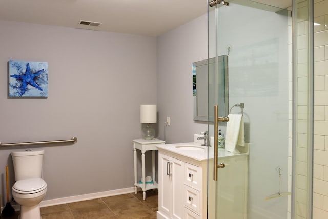 bathroom with vanity, tile patterned flooring, a shower with shower door, and toilet