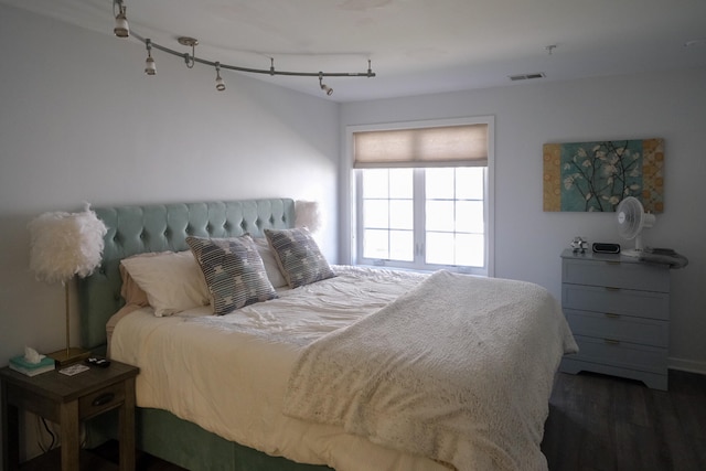 bedroom with dark wood-type flooring