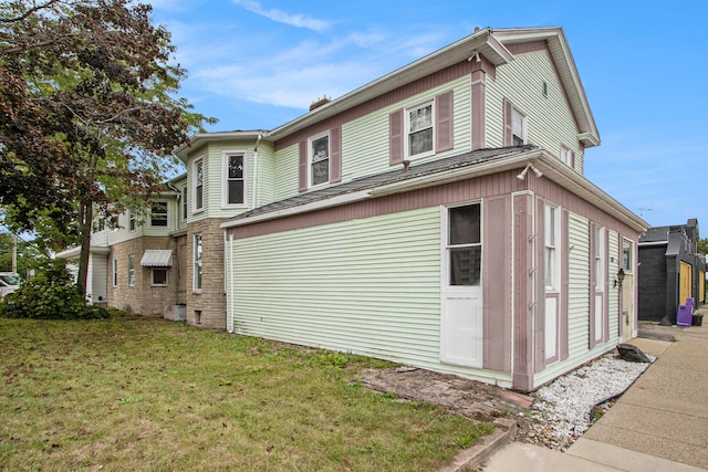 view of property exterior featuring a lawn