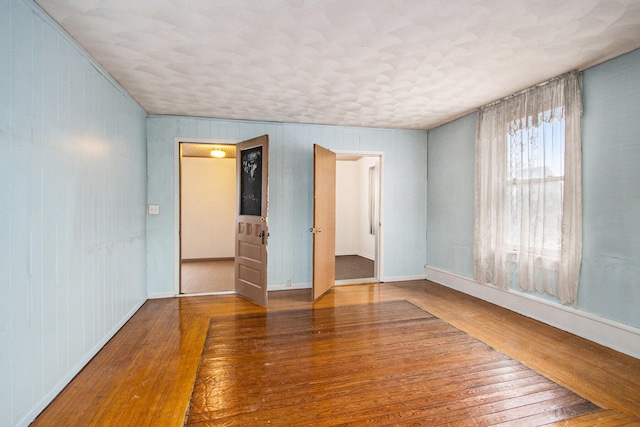 unfurnished room featuring hardwood / wood-style floors