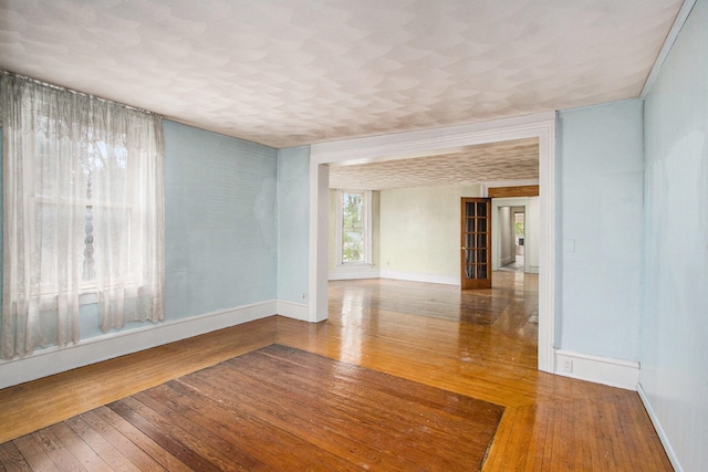 unfurnished room with hardwood / wood-style flooring