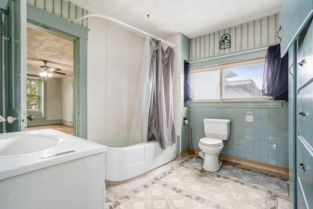 full bathroom with ceiling fan, vanity, toilet, and shower / bathtub combination with curtain