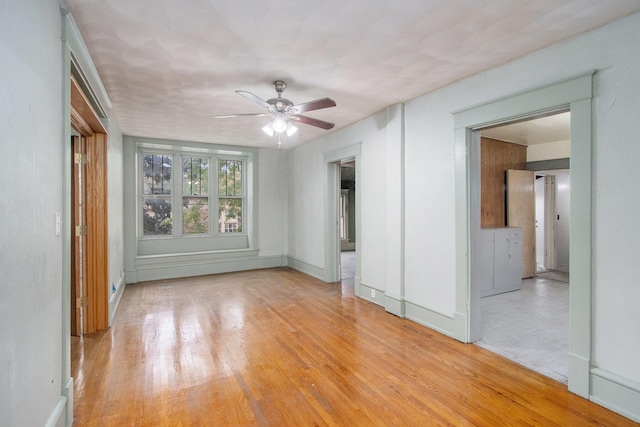 unfurnished room featuring light hardwood / wood-style floors and ceiling fan