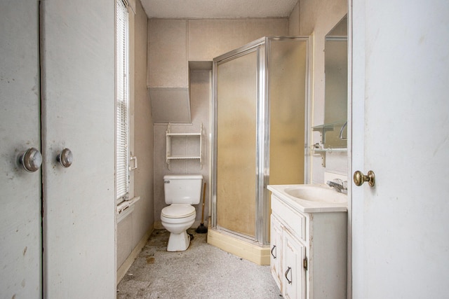 bathroom with a shower with door, vanity, and toilet