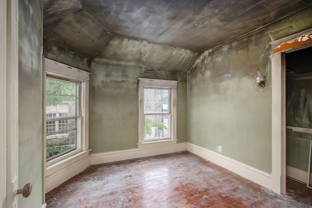 unfurnished room featuring lofted ceiling